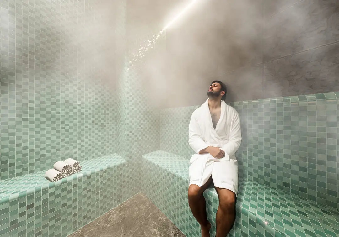 Baño de vapor revestido en mosaico verde agua