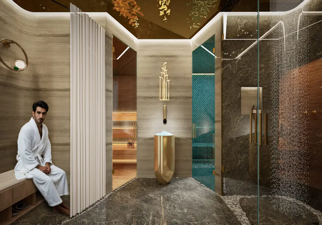Vestidor del spa con regaderas y acabados de mármol